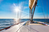 Sailing boat at calm open sea on a bright sunny day