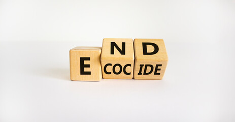 End ecocide symbol. Turned wooden cubes with words end ecocide. Beautiful white background, copy space. Business, ecological and end ecocide concept.