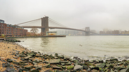Fototapete - Brooklyn bridge at foggy rainy day, New York City