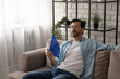 © fizkes - Frustrated guy recline on sofa suffer from too hot temperature at home breath hard with dehydrated air cool down with hand fan. Tired young male complain on extra heat at living room feel bad sweaty