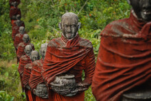 Old Statues Of Buddhist Monks Collecting Alms Surround The Win Sein Taw Ya Buddha In Mawlamyine, Myanmar (Burma).