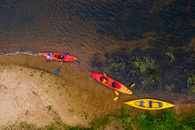 Multicolored Empty Kayaks On The River Bank, View From Above