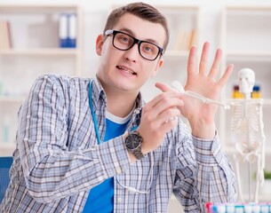 Wall Mural - Medical student studying skeleton in classroom during lecture