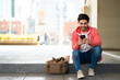 © Mego-studio - Young man using his mobile phone outdoors.