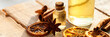 Concept of natural essential oils: orange, cinnamon sticks, anise. Home spa treatment. Aromatherapy, holiday spirit. Winter home fragrances blend. Bright light, close up. Copy space for text, banner
