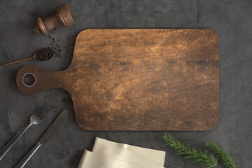 Old Wooden cutting board and Kitchen utensils on a Concrete background, Free space for your text