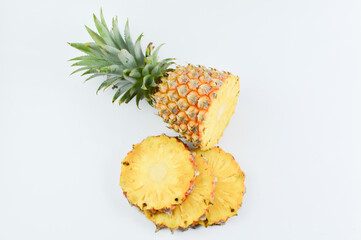 Pineapple slices with leaves over white background.