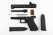 © Atlantist studio - Parts of .45 semi automatic pistol handgun with bullets on white background , Gun disassembled