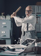 Crazy businessman destryoing his office with a baseball bat