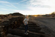 © Mint Images - 7 year old boy standing alone on railroad ties at sunset