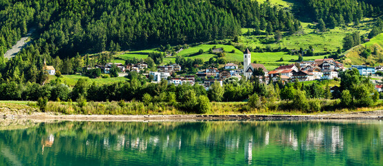 Sticker - Graun im Vinschgau or Curon Venosta, a town on Lake Reschen in South Tyrol, Italian Alps