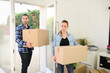 © W PRODUCTION - happy young couple moving carboard boxes and furnitures during move into a new home flat apartment