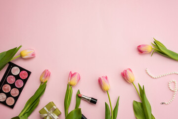 Tulips, cosmetics and fashion accessories on a pink background. Spring, mother's day, gifts concept.