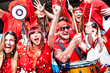 © Mirko Vitali - Football supporter fans cheering with confetti watching soccer match cup at stadium tribune - Young people group with red t-shirt having excited fun on sport world championship - Bright vivid filter