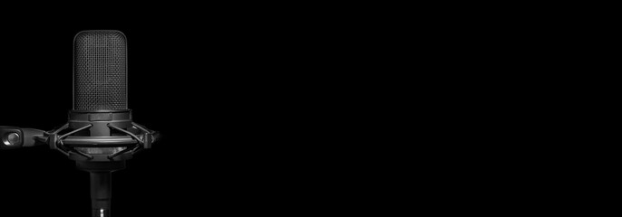 Recording studio microphone in the dark. Music production, broadcast, podcast or dubbing background banner with copy space