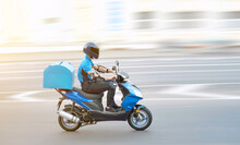 Food Delivery Boy On Motorcycle Moving Fast To Deliver Food To Customers, Home And Office Delivery On Motorbike, Pizza Online Order. Express Delivery Service From Cafes And Restaurant, Internet Orders