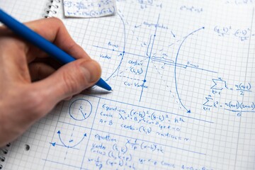 Math exersize in white notebook closeup