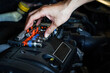 © Apicha - Auto mechanic working in garage. Repair service,Car check concept