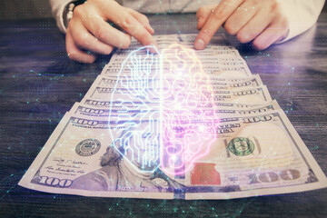 Multi exposure of brain drawing hologram and us dollars bills and man hands. Ai invest concept