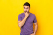 © luismolinero - Young caucasian handsome man isolated on yellow background thinking
