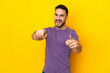 © luismolinero - Young caucasian handsome man isolated on yellow background pointing front with happy expression