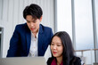 © SEVENNINE_79 - Confident and smart beautiful businesswoman in formal attire stands in the office. With a group of friends and laptop in the background. A cheerful idea to work within the workspace.