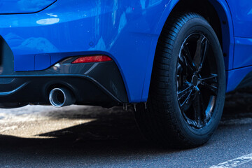 Wall Mural - close-up of a blue car parked on the side of the street