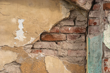 Wall Mural - Old damaged plastered facade house wall closeup as grunge background