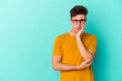 © Asier - Young caucasian man isolated on blue background who feels sad and pensive, looking at copy space.