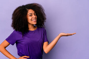 Young african american curly woman isolated on purple background showing a welcome expression.