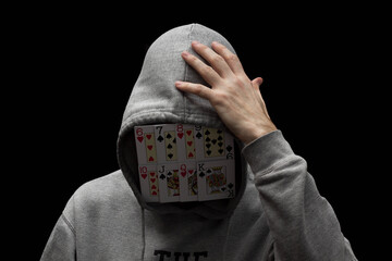 Wall Mural - Man in hoodie with mask of playing cards hiding face