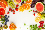 Fototapeta Uliczki - Assorted fresh fruits and berries on white background. Clean eating, healthy life. Top view.