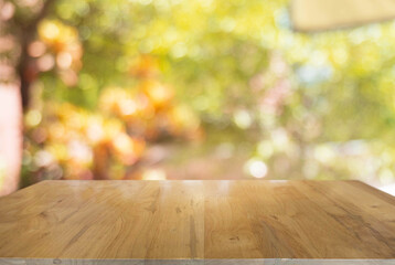 Empty dark wooden table in front of abstract blurred bokeh background of restaurant . can be used for display or montage your products.Mock up for space