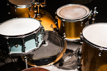 closeup professional musical instrument. drum kit for jazz band in recording studio. drumsticks lyin