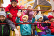 © oksix - Cheerful kids at outdoor playground in early spring