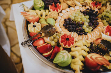 Wall Mural - Closeup of beautifully decorated fruits on a large tray, fruit party tray