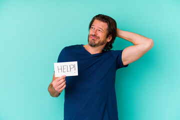 Middle age dutch man holding a help placard isolated on blue background touching back of head, thinking and making a choice.