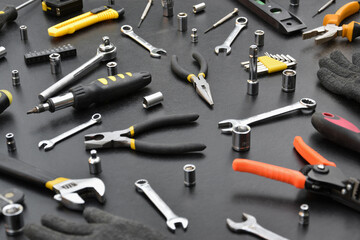 Wall Mural - Handyman tool kit on black wooden table. Many wrenches and screwdrivers, pilers and other tools for any types of repair or construction works. Repairman tools