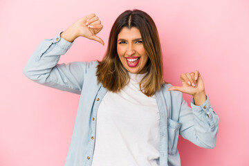 Wall Mural - Young indian woman isolated on pink background feels proud and self confident, example to follow.