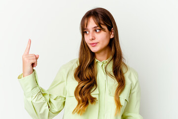 Wall Mural - Young caucasian cute woman isolated on white background pointing with finger at you as if inviting come closer.