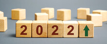 Wooden Blocks With The Inscription 2022 And An Up Arrow. The Forecast Concept For 2022. Business Forecasting. Growth And Development Of Business And Economy. Vision. Targets And Goals
