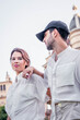 © patoouupato - young man and woman couple in outdoor city park with white and light clothes in spring summer 2021