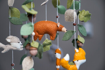 Diy craft baby crib mobile. Toys hang over the crib