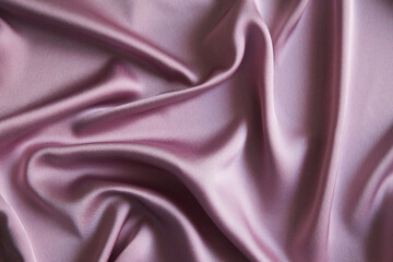 Beautiful smooth elegant wavy pink satin silk luxury fabric, fabric texture, abstract background design. Copy space
