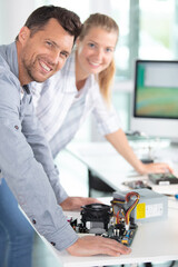 woman repairing computer part in service center