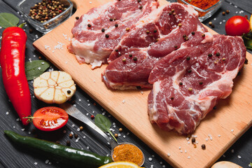 Wall Mural - Raw pork chop steak prepare in kitchen with vegetable and spices for food and cooking concept.