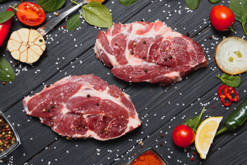 Wall Mural - Raw pork chop steak prepare in kitchen with vegetable and spices for food and cooking concept.