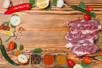 Wall Mural - Raw pork meat with spices and vegetables on wooden table