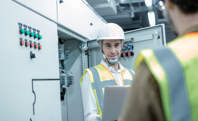 Electrician engineer tests electrical installations and wires on relay protection system. Bay control unit. Medium voltage switchgear	
