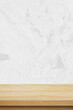 © mangpor2004 - Vertical brown wood table and white cement wall background in kitchen, Wooden shelf, counter for food and product display in room background, Wood table top, desk surface banner, mockup, template